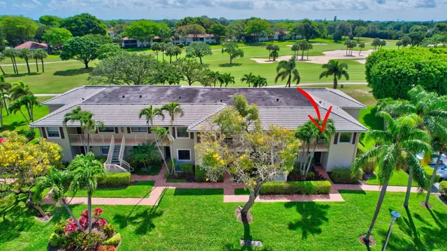 a kitchen with stainless steel appliances a stove a sink a refrigerator white cabinets and wooden floor