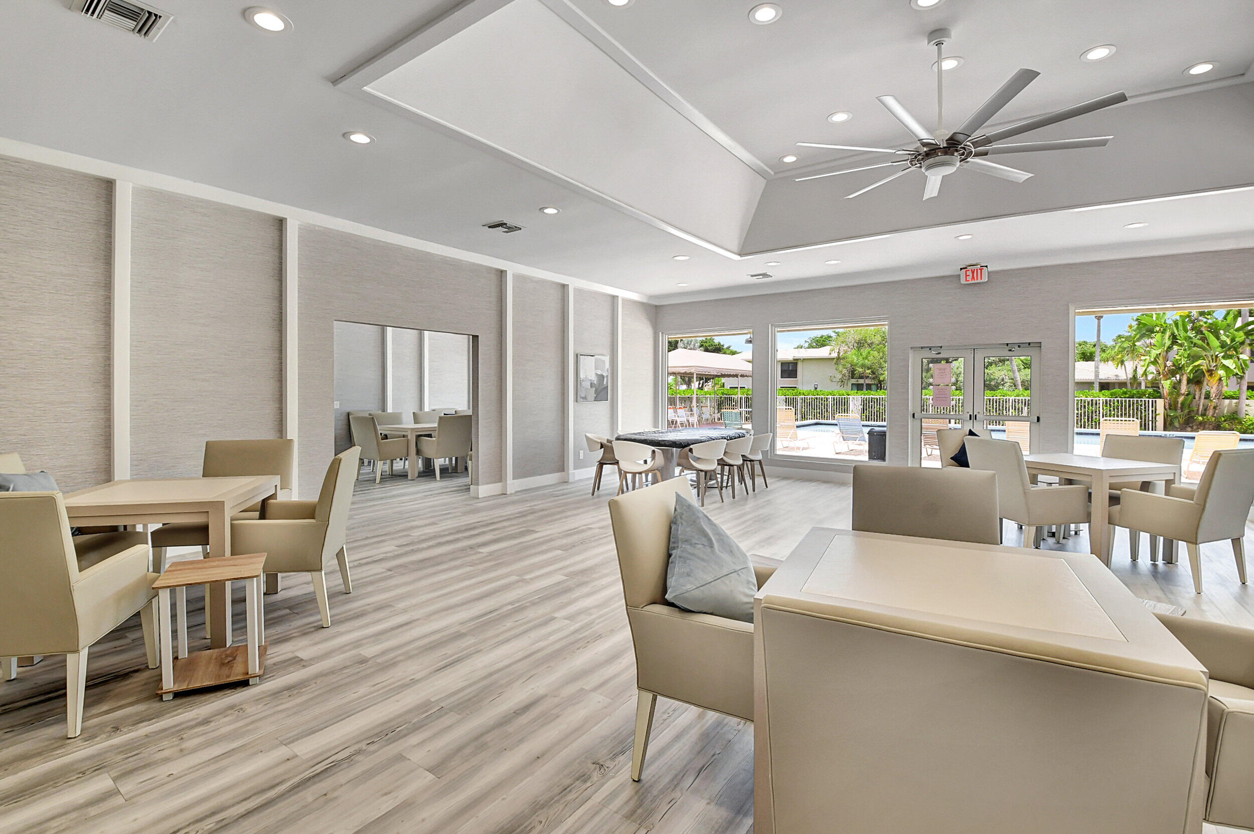 3 Stratford Drive, Unit H Boynton Beach, FL 33436 - Photo 44 of 81 a living room with furniture a large window and wooden floor