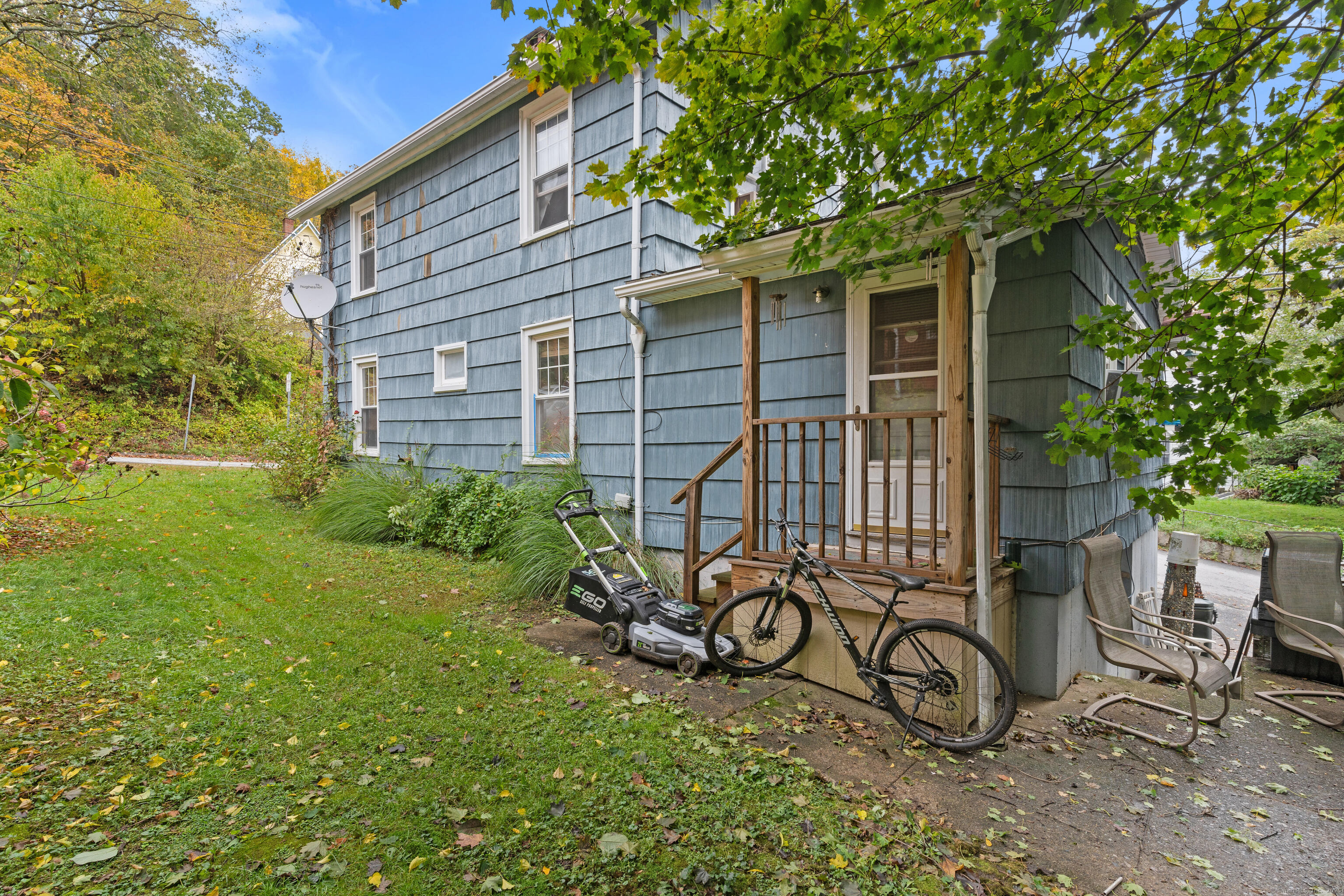 104 Judson Street Thomaston, CT 06787 - Photo 19 of 24 a view of a backyard with a table and chairs and a large tree