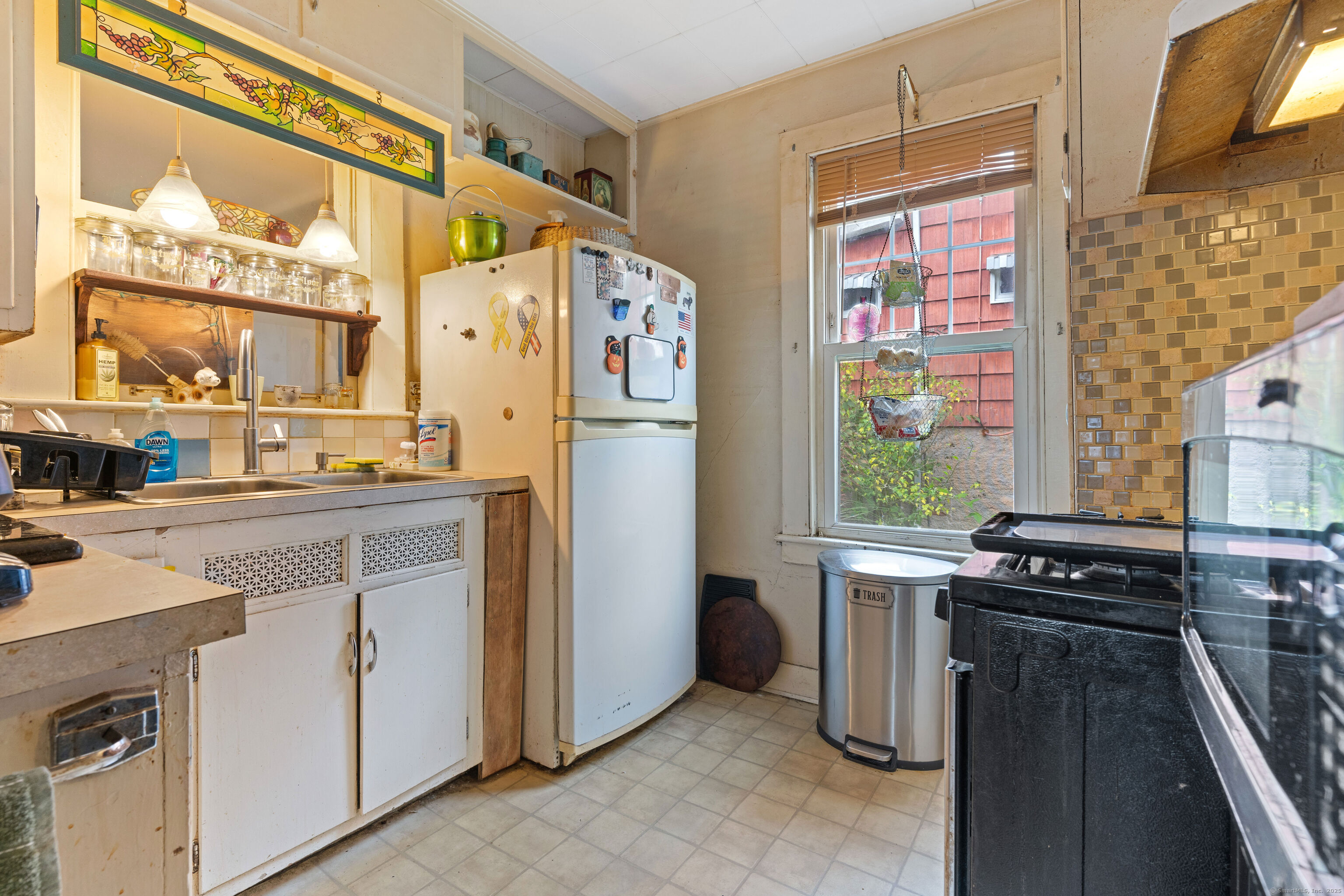 104 Judson Street Thomaston, CT 06787 - Photo 3 of 24 a kitchen with a refrigerator and a stove