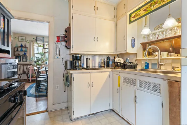 a kitchen with a refrigerator and a stove