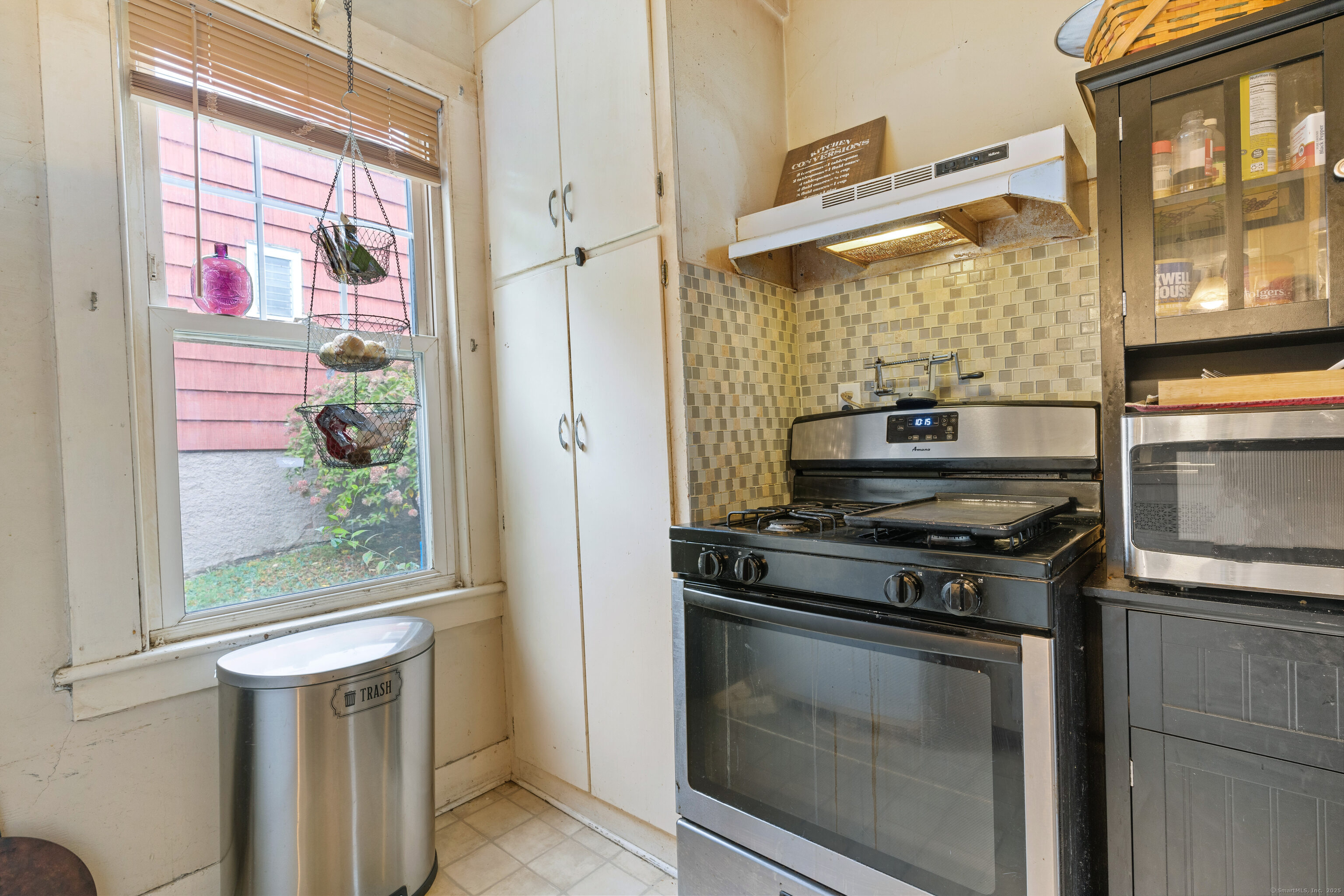 104 Judson Street Thomaston, CT 06787 - Photo 5 of 24 a kitchen with a stove and a wooden floor