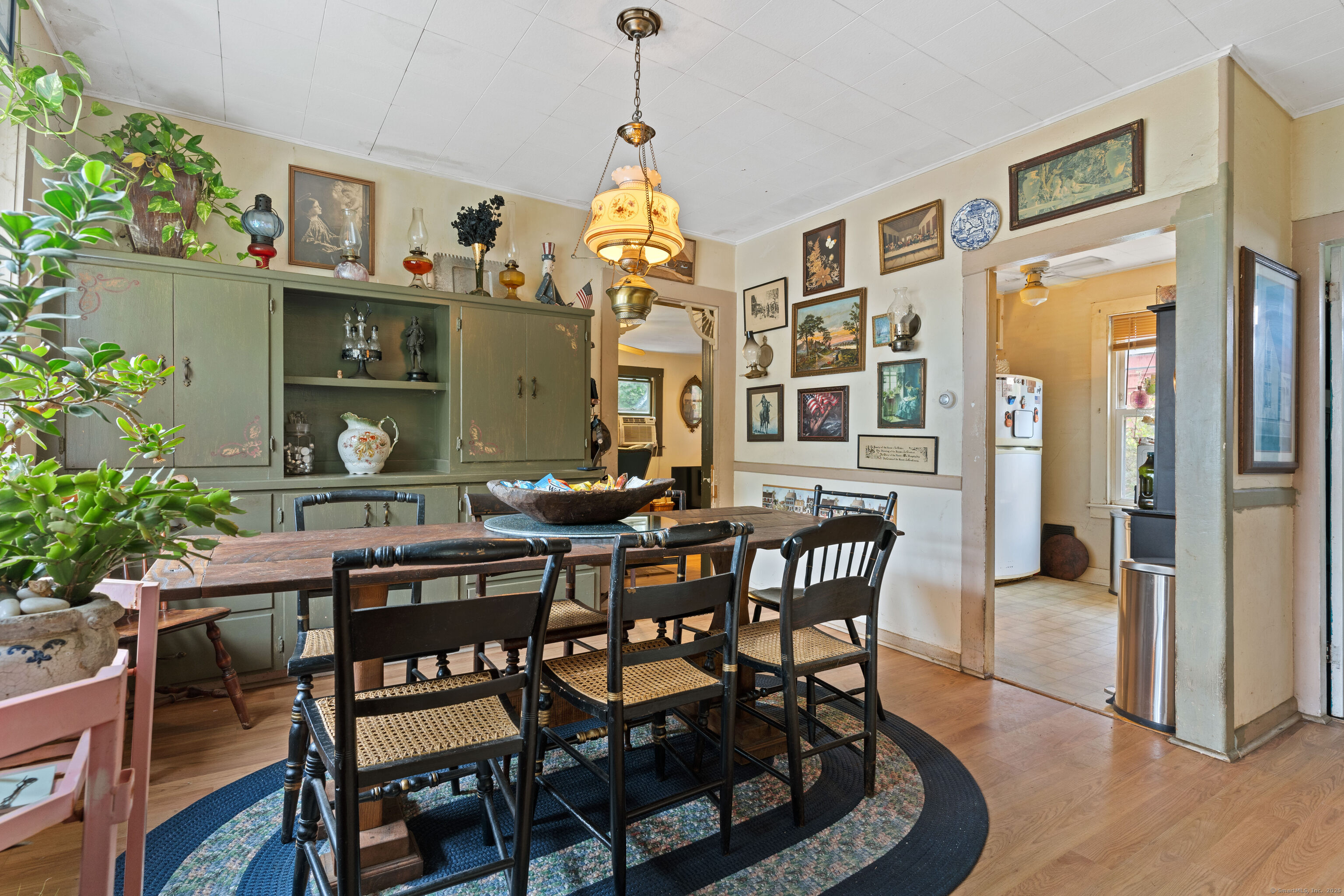 104 Judson Street Thomaston, CT 06787 - Photo 6 of 24 a view of a dining room with furniture and a potted plant