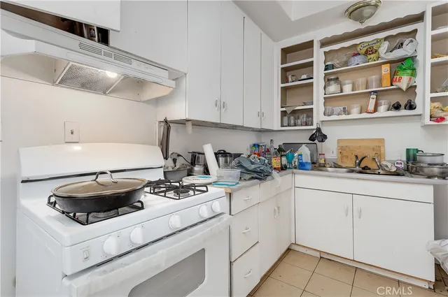 a kitchen with stainless steel appliances granite countertop a sink a stove and cabinets
