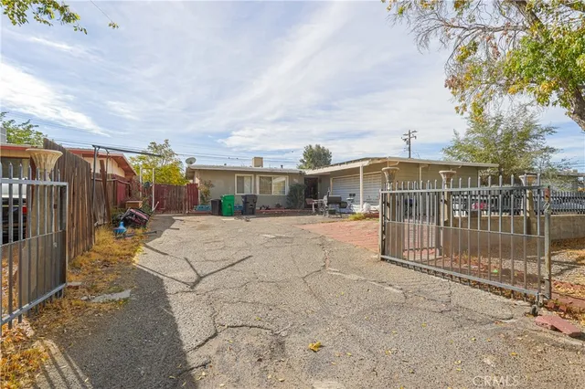 a view of backyard with swimming pool and furniture