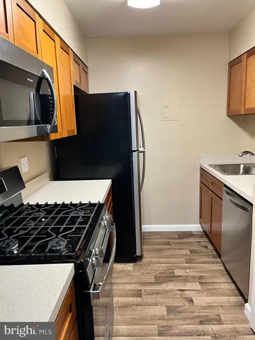 a kitchen with stainless steel appliances a stove and a microwave