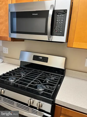 a stove top oven sitting inside of a kitchen