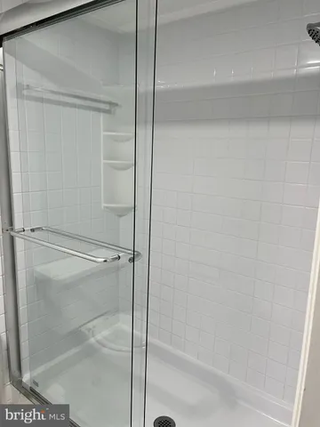 a bathroom with a glass shower door