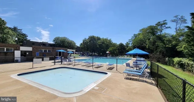 swimming pool view with a seating space
