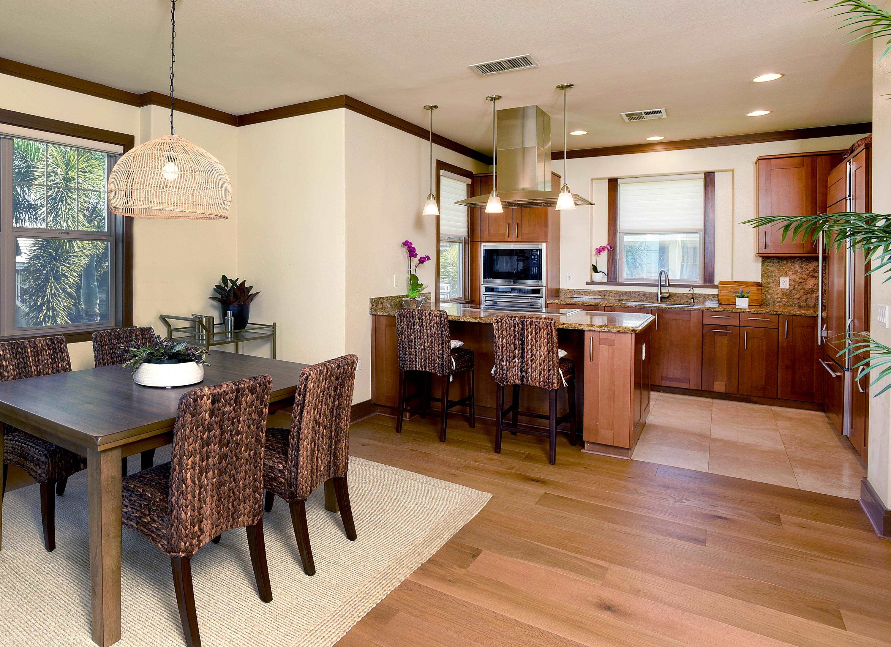 71 Poailani Place, Unit 14 Kihei, HI 96753 - Photo 5 of 23 a kitchen with stainless steel appliances kitchen island granite countertop a table chairs and a refrigerator