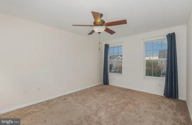a view of empty room with ceiling fan