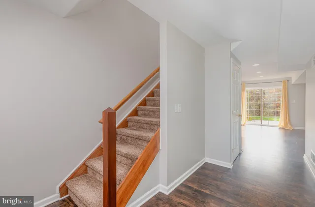 a view of an entryway with wooden floor and stairs
