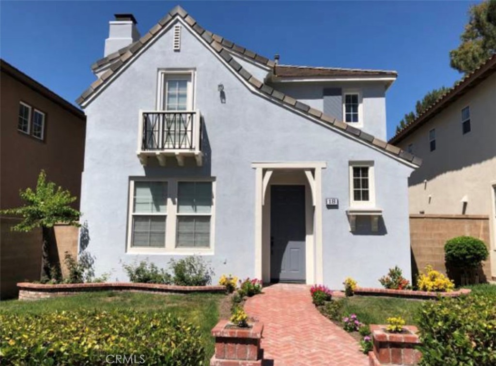 18 Avalon, Unit 5 Irvine, CA 92602 - Photo 1 of 6 a front view of a house with a yard