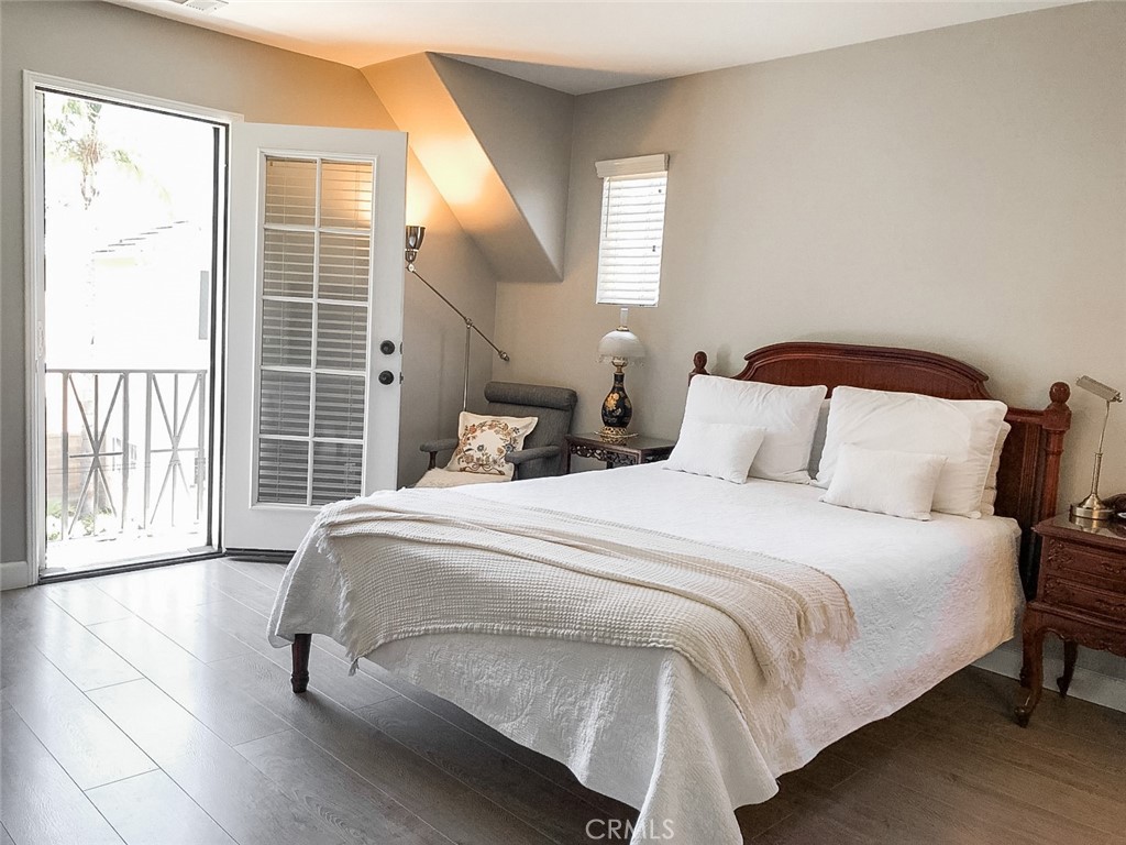 18 Avalon, Unit 5 Irvine, CA 92602 - Photo 6 of 6 a bedroom with a bed and wooden floor