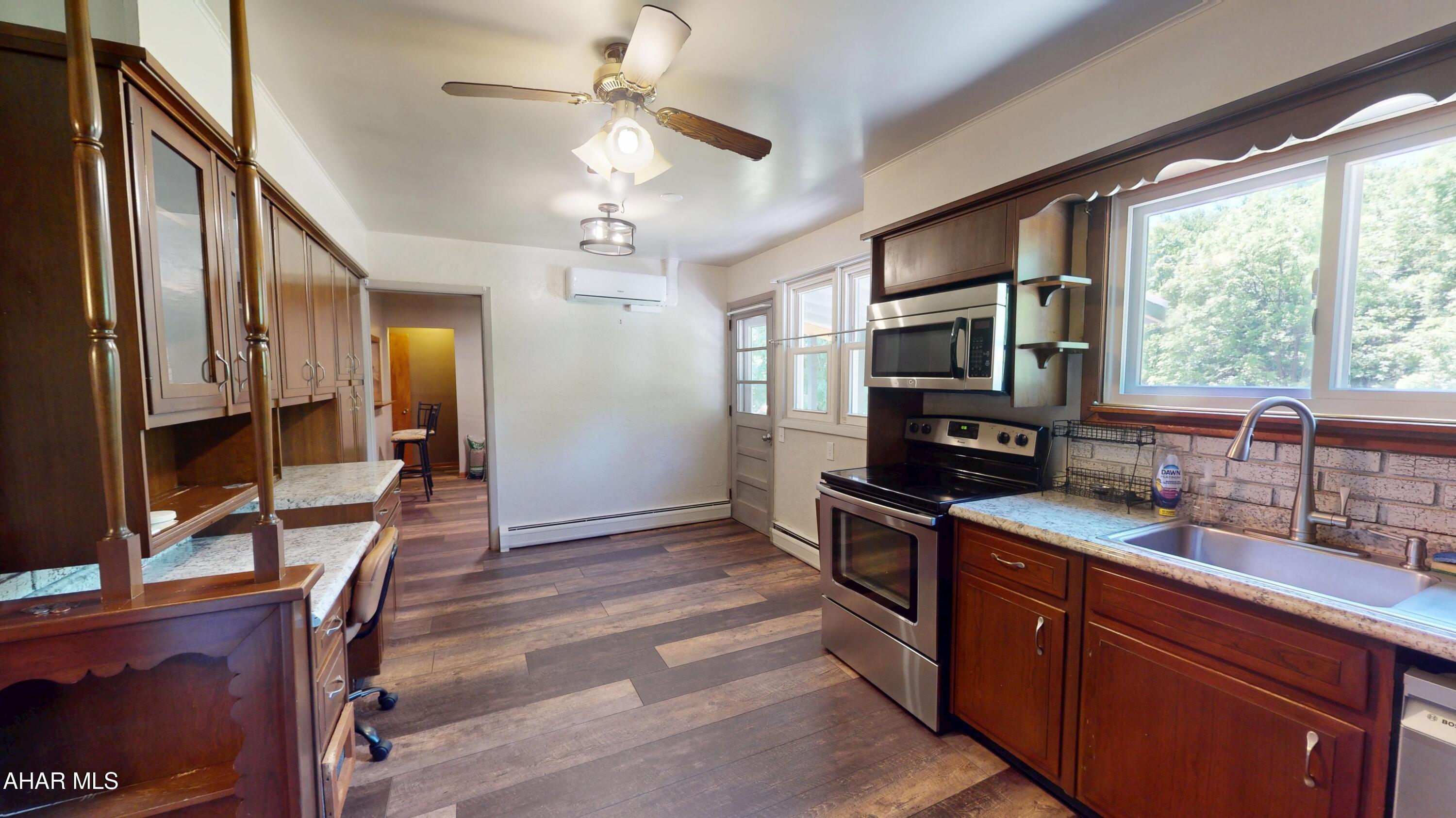 871 Decker Hollow Road Tyrone, PA 16686 - Photo 15 of 35 a kitchen with granite countertop a sink appliances cabinets and furniture