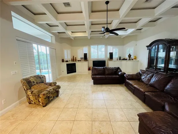 a living room with furniture and kitchen view