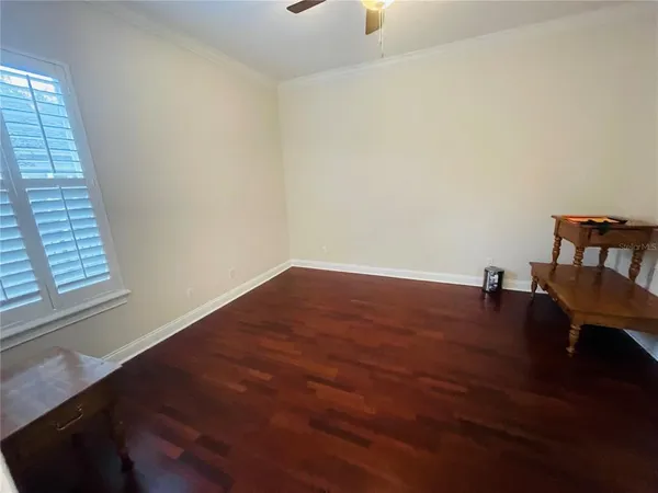 a view of a room with wooden floor and a window