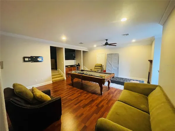 a living room with furniture and a wooden floor