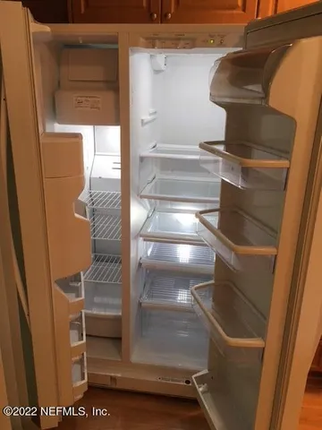 a view of a yard with potted plants and trees