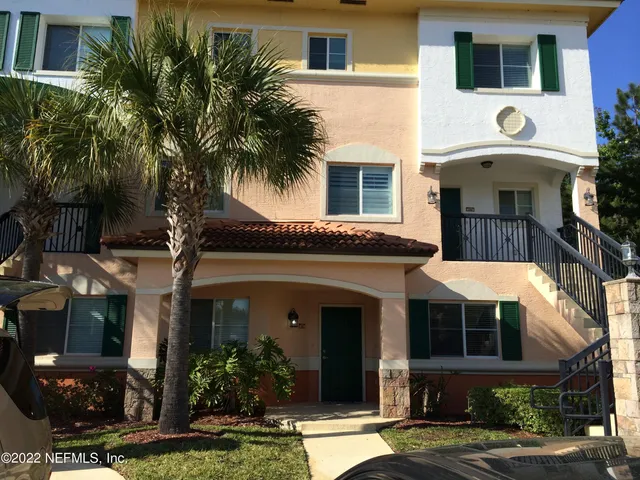 a view of a living room with furniture and wooden floor