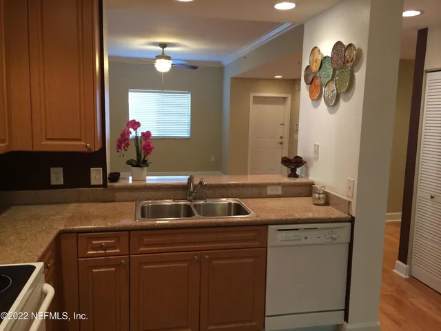 a kitchen with stainless steel appliances granite countertop a sink and cabinets