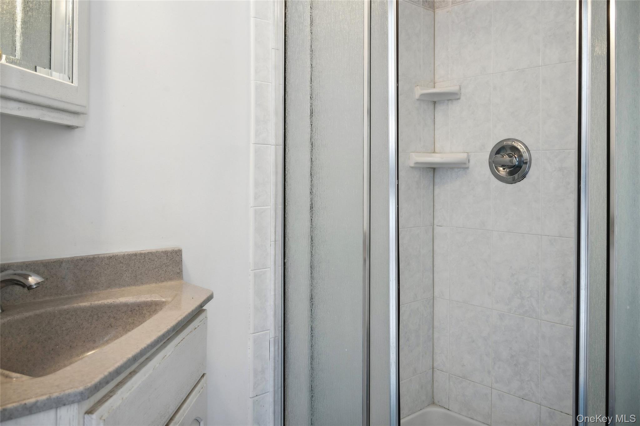 846 Dune Road Westhampton Beach, NY 11978 - Photo 18 of 34 Bathroom with vanity and an enclosed shower