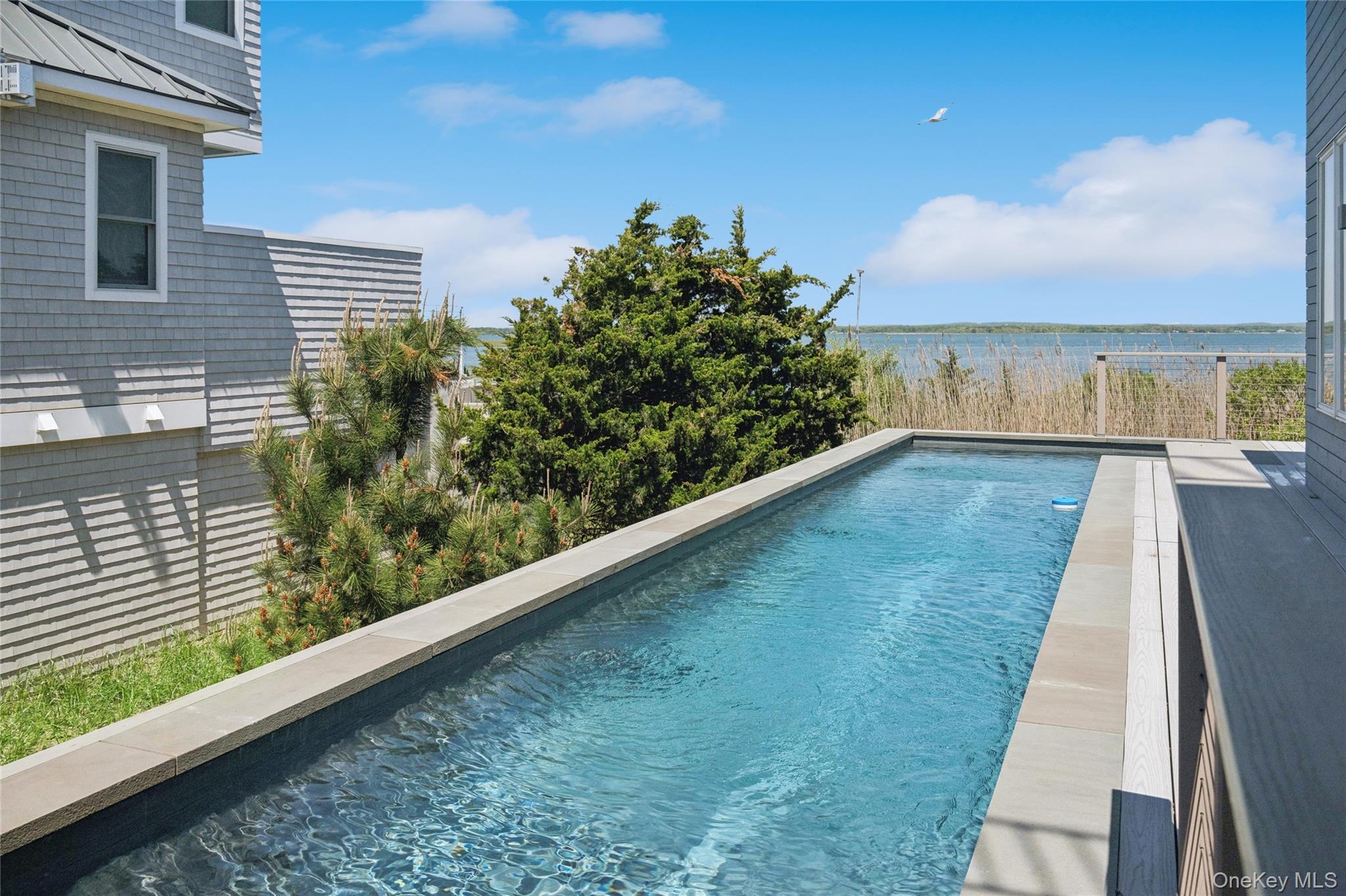 846 Dune Road Westhampton Beach, NY 11978 - Photo 10 of 34 Outdoor pool featuring a water view
