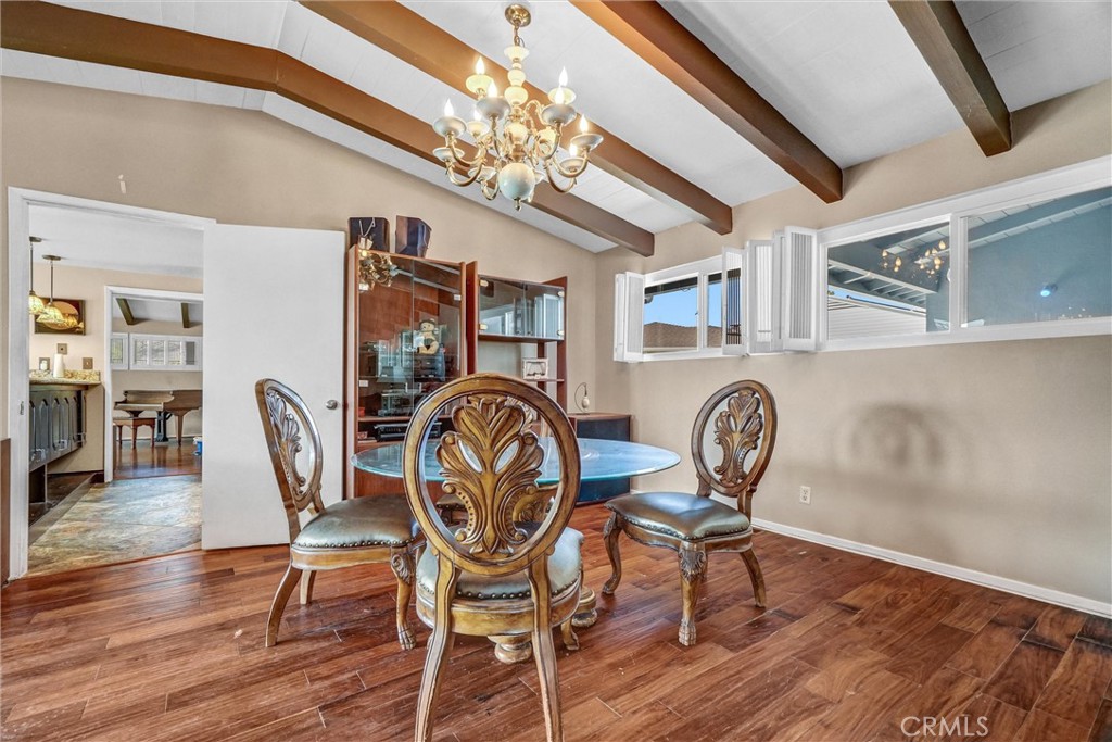 994 North Cleveland Street Orange, CA 92867 - Photo 13 of 53 a dining room with furniture a chandelier and wooden floor