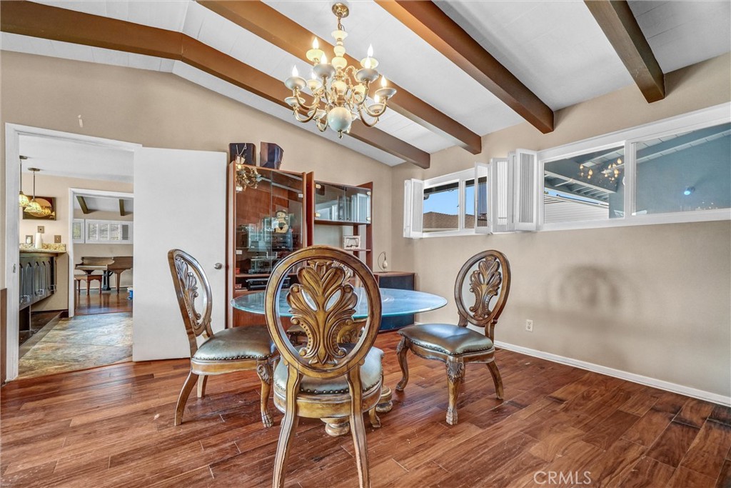 994 North Cleveland Street Orange, CA 92867 - Photo 13 of 53 a dining room with furniture a chandelier and wooden floor