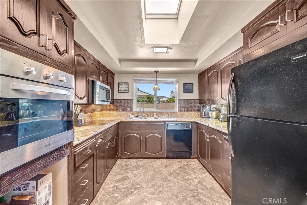 994 North Cleveland Street Orange, CA 92867 - Photo 16 of 53 a large kitchen with stainless steel appliances granite countertop a sink and cabinets