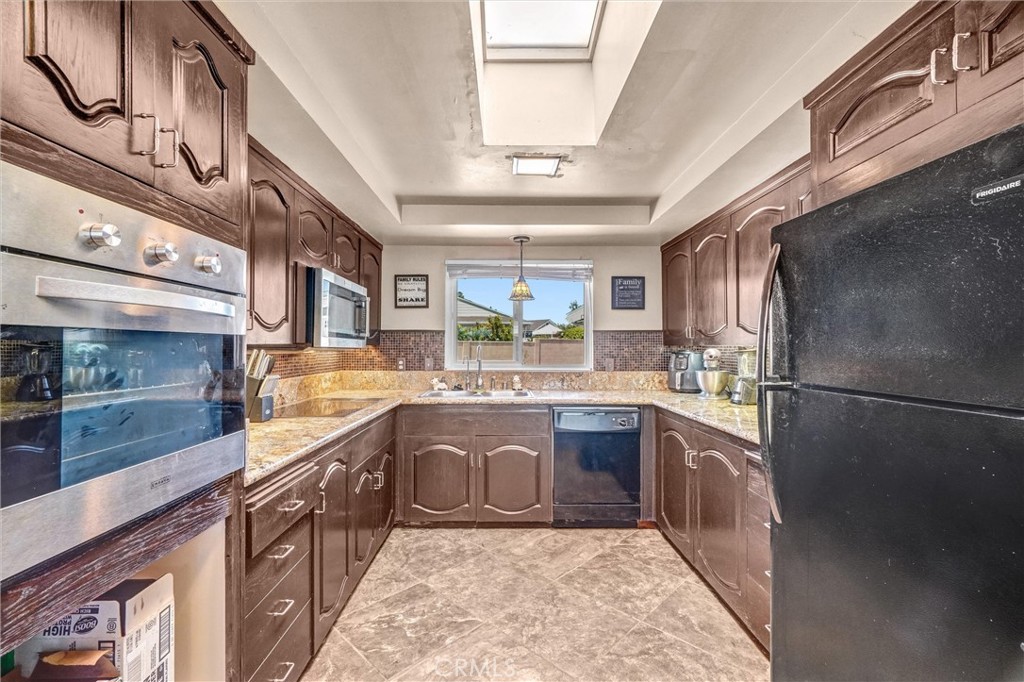 994 North Cleveland Street Orange, CA 92867 - Photo 16 of 53 a large kitchen with stainless steel appliances granite countertop a sink and cabinets