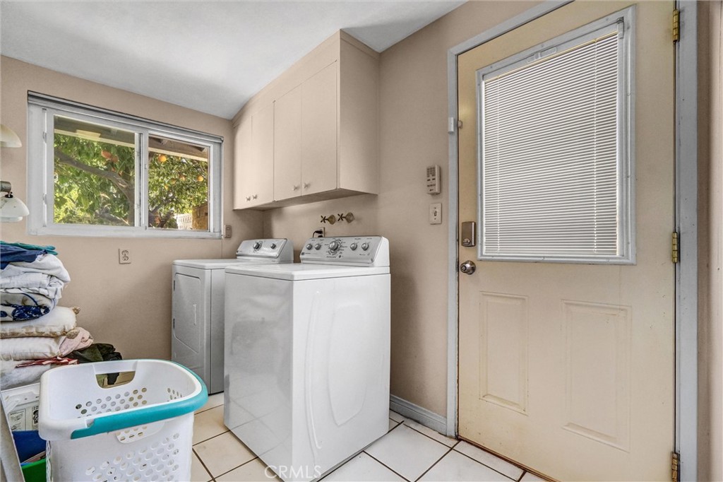 994 North Cleveland Street Orange, CA 92867 - Photo 23 of 53 a utility room with cabinets washer and dryer