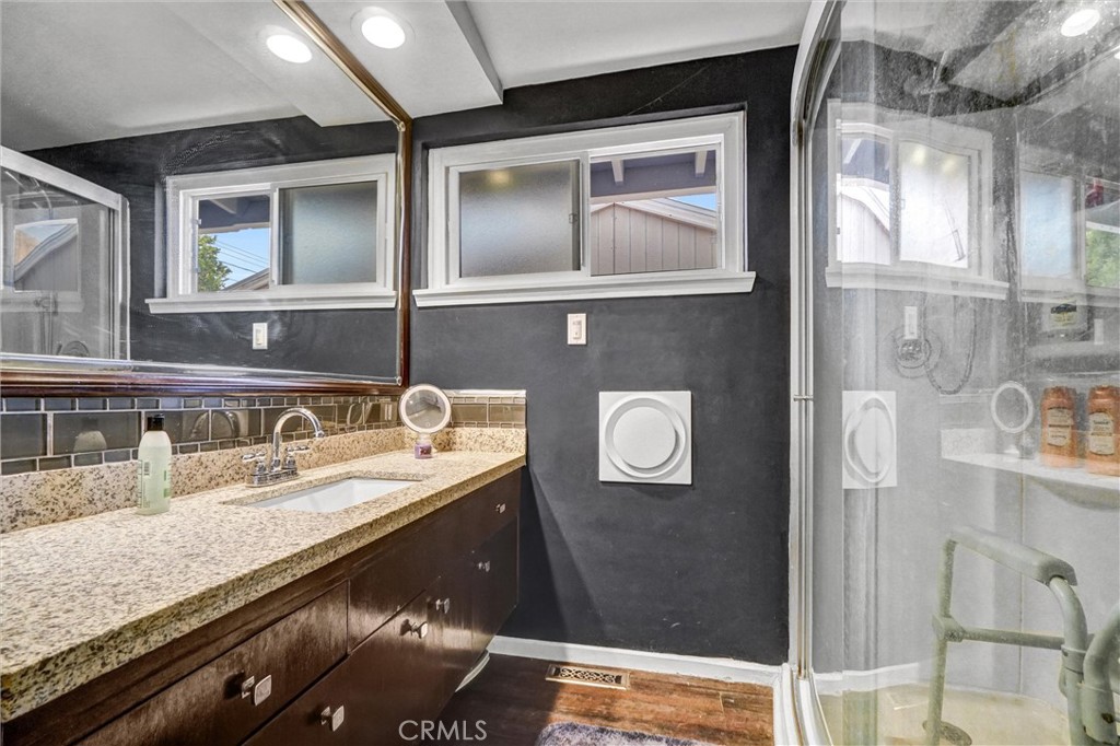 994 North Cleveland Street Orange, CA 92867 - Photo 26 of 53 a bathroom with a granite countertop sink a mirror and shower