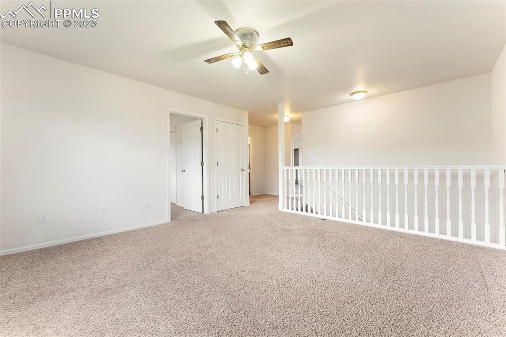 12210 Crystal Downs Road Peyton, CO 80831 - Photo 12 of 50 Carpeted empty room with baseboards and ceiling fan