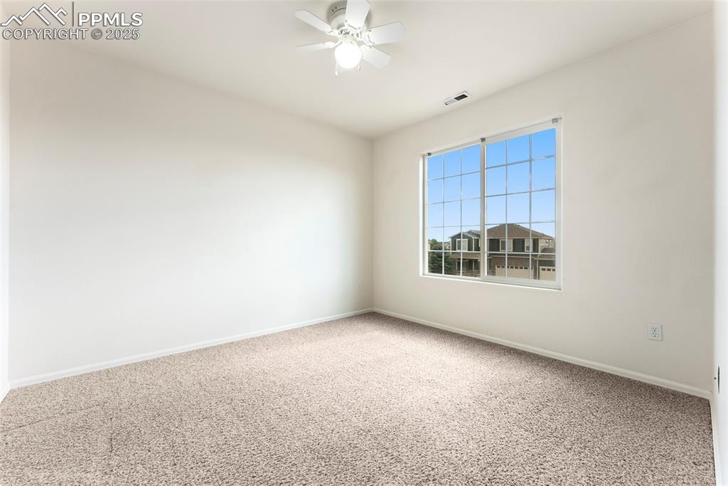 12210 Crystal Downs Road Peyton, CO 80831 - Photo 26 of 50 Carpeted spare room featuring baseboards and a ceiling fan