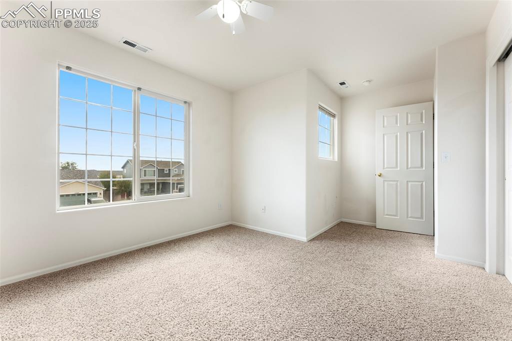 12210 Crystal Downs Road Peyton, CO 80831 - Photo 27 of 50 Unfurnished bedroom featuring light carpet and ceiling fan