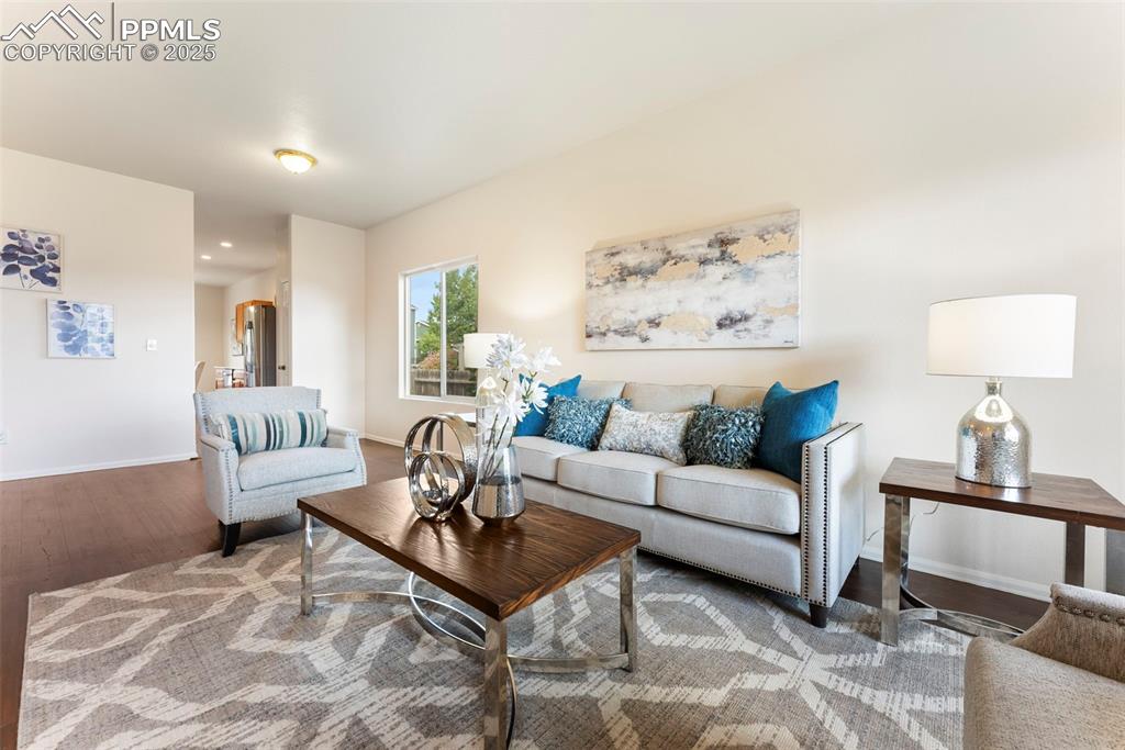 12210 Crystal Downs Road Peyton, CO 80831 - Photo 3 of 50 Living area featuring wood finished floors and baseboards