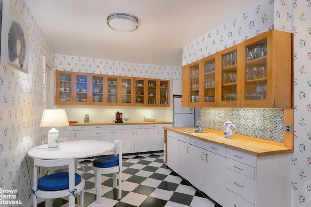 a large white kitchen with a sink and a stove