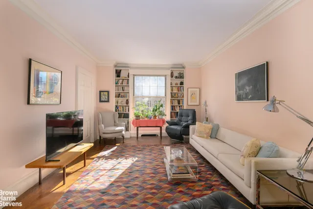 a living room with furniture wooden floor and a flat screen tv
