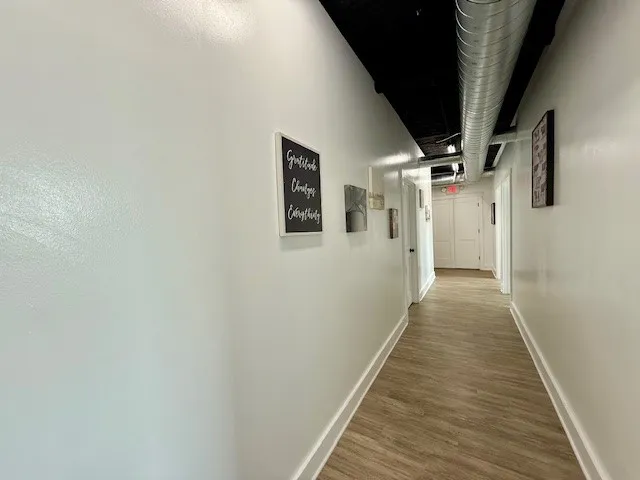 a view of a hallway with wooden floor
