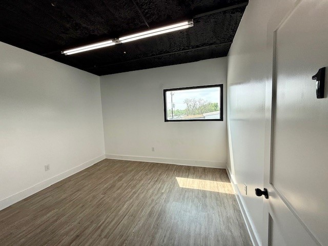 617 Main Street Lexington, TX 78947 - Photo 18 of 25 Spare room with baseboards and luxury vinyl plank floors