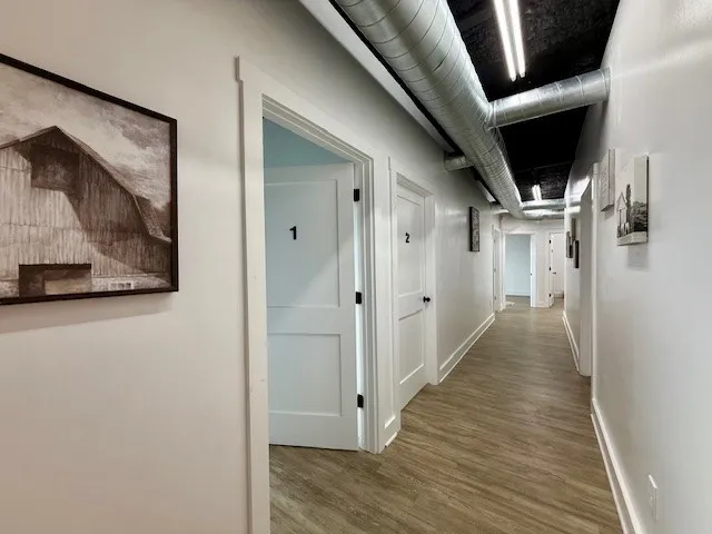 a view of hallway with wooden floor