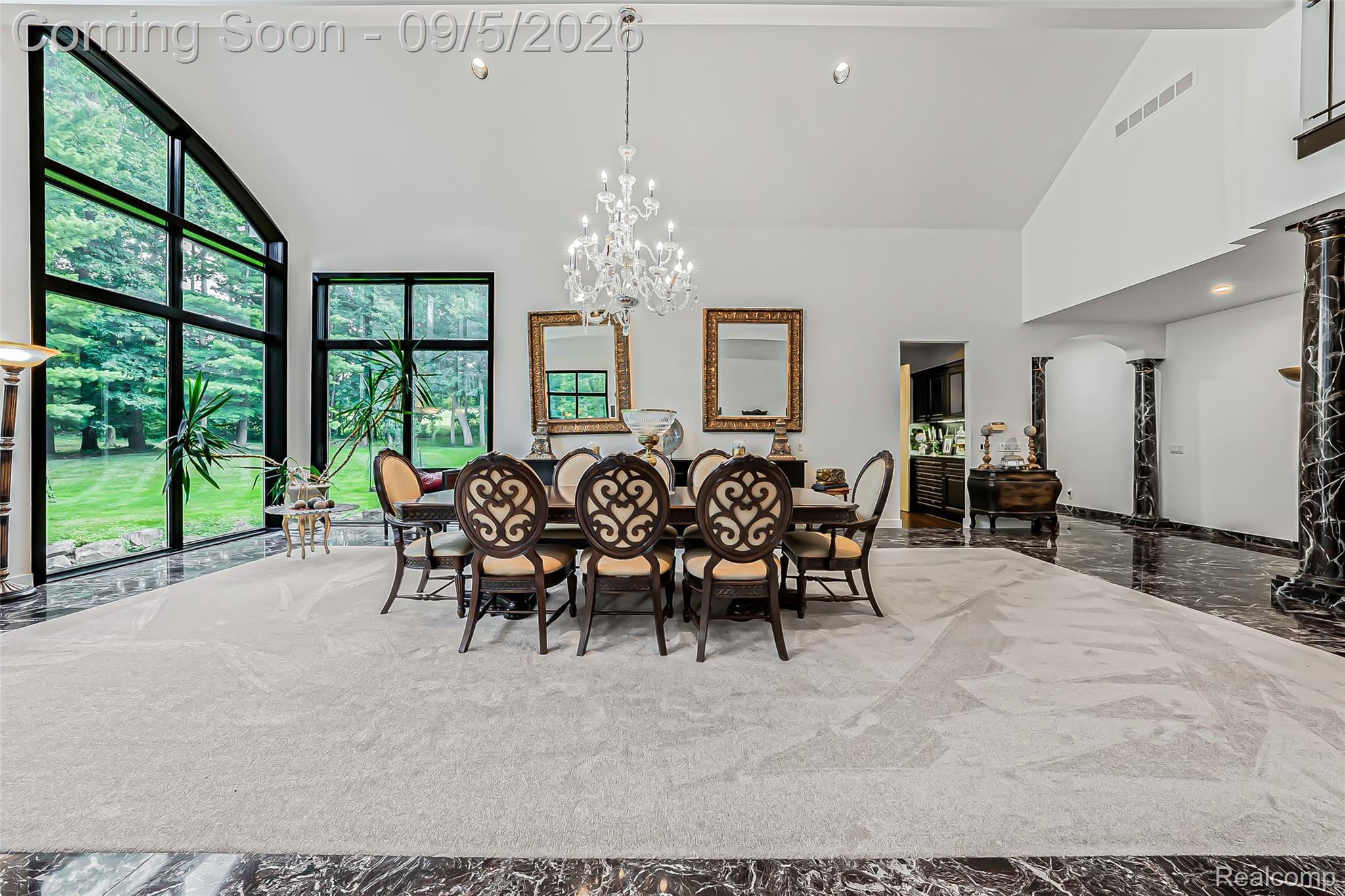 2785 Cranbrook Ridge Court Rochester, MI 48306 - Photo 31 of 97 Two-story vaulted ceiling with a crystal chandelier, black-veined marble flooring, and expansive windows