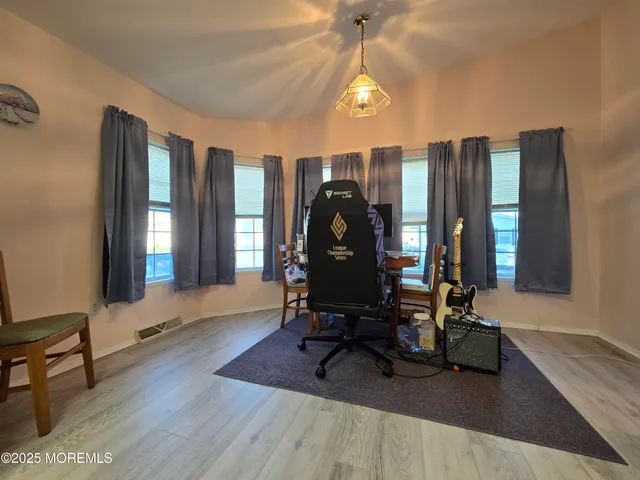 a view of a workspace with furniture and a window