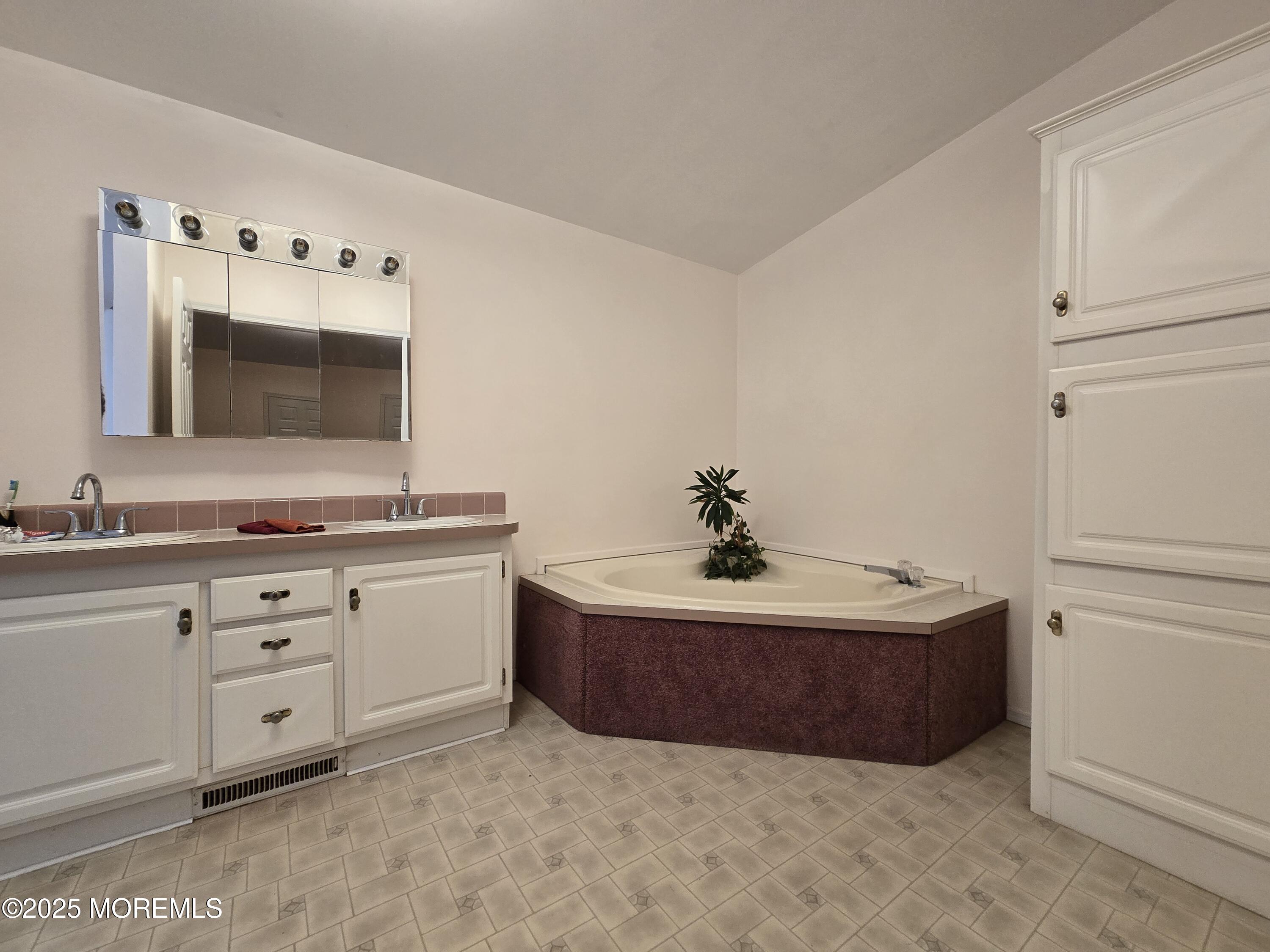 98 Woody Road Freehold, NJ 07728 - Photo 18 of 37 a bathroom with a sink and a mirror