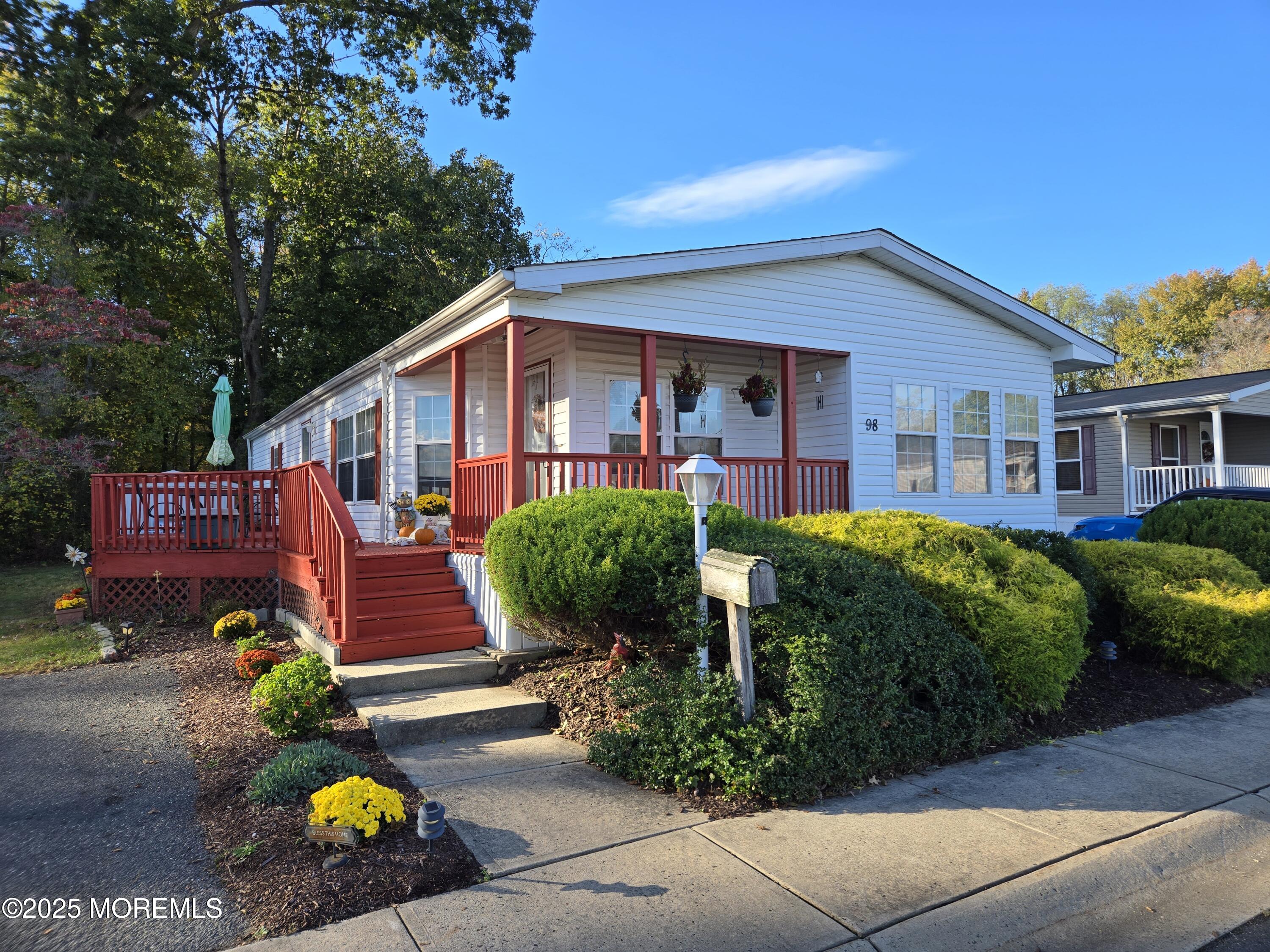 98 Woody Road Freehold, NJ 07728 - Photo 2 of 37 a front view of a house with garden and plants