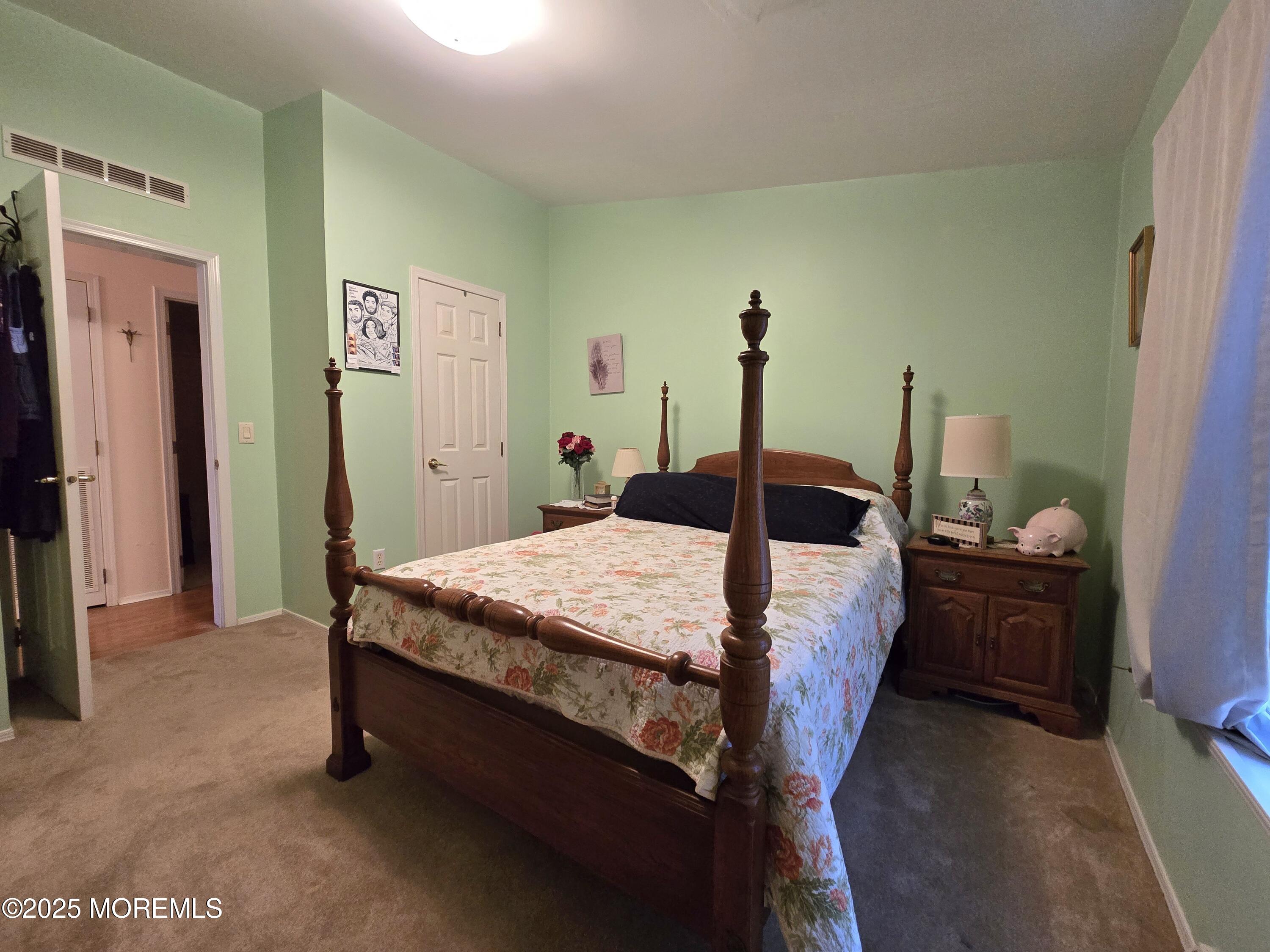 98 Woody Road Freehold, NJ 07728 - Photo 22 of 37 a bed sitting in a bedroom next to a window