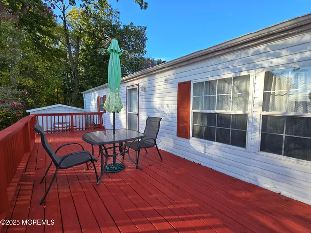 a view of a house with a porch and furniture
