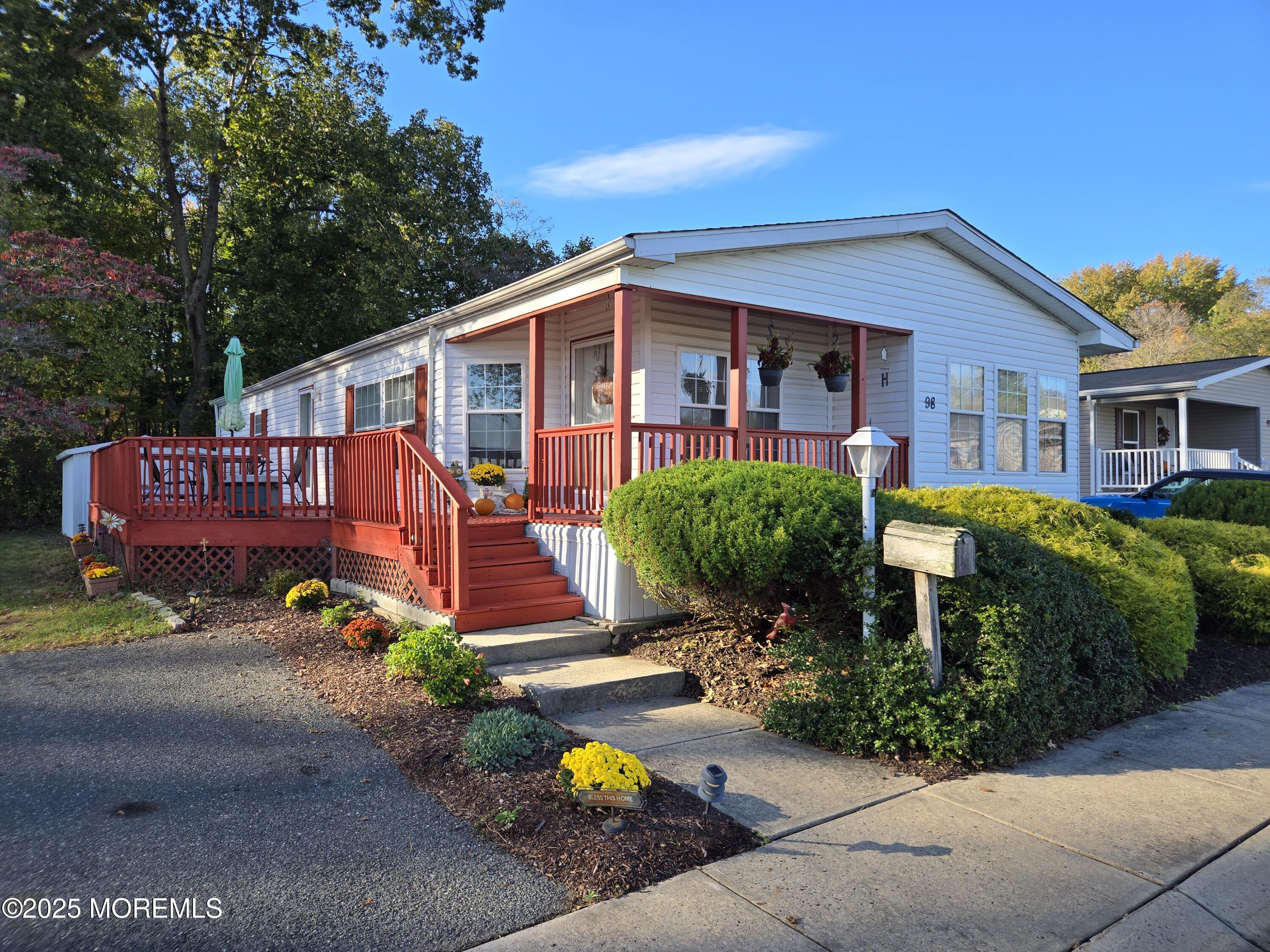 98 Woody Road Freehold, NJ 07728 - Photo 33 of 37 a front view of a house with yard and a garden