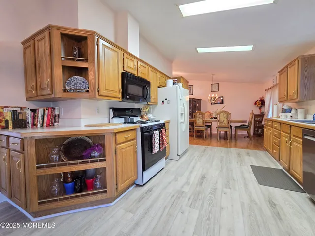 a kitchen with stainless steel appliances granite countertop a stove and cabinets